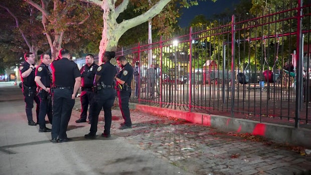 NYPD officers standing outside playground