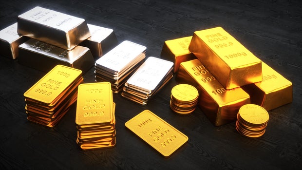 Stacks of precious metal ingots and coins 