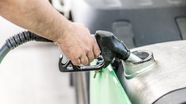 A man fills a truck with diesel fuel 