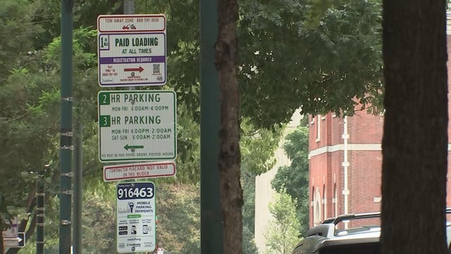 A sign indicating that it's a paid loading zone on a Philadelphia street 