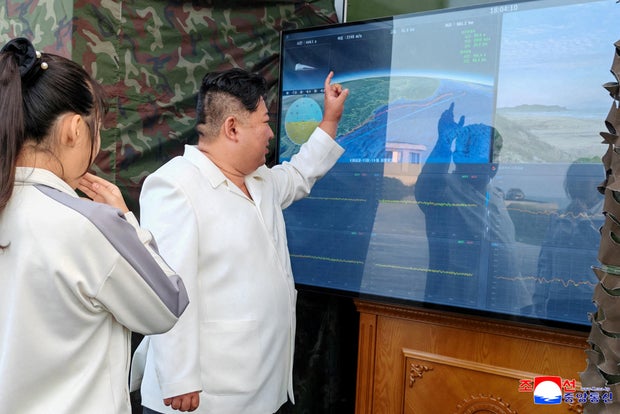 North Korean leader Kim Jong Un, accompanied by his daughter Kim Ju Ae, attends a test of a new type of weapon at an undisclosed location