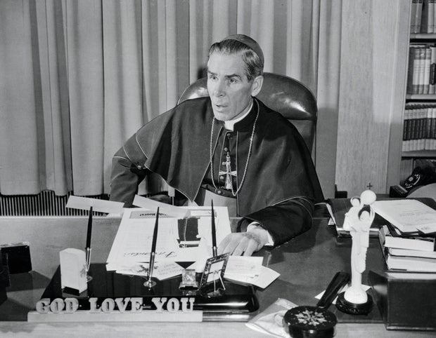Bishop Fulton Sheen Sitting with Arms Folded