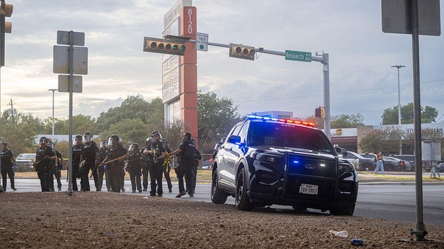 Law enforcement retreat as people protest against ICE on Sept. 20, 2026 in Austin, Texas. 