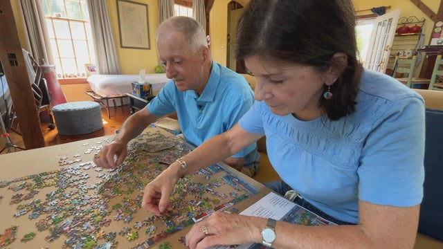 The Legeres work on a puzzle at their Hosts for Hospitals home 