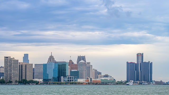 Detroit skyline stretching across the river beneath layered 