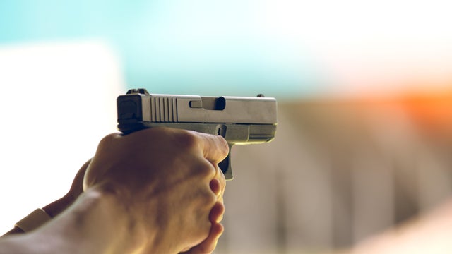 hand aim pistol in academy shooting range 