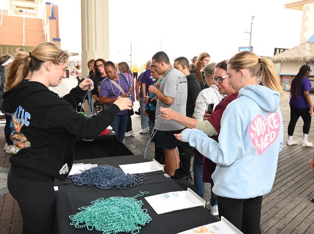 People post for photos at the Out of the Darkness Walk on benefiting the American Foundation for Suicide Prevention