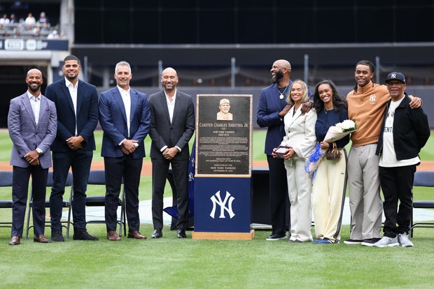 CC Sabathia poses for a photo with his former teammates and family during his number retirement ceremony on the field prior to the game between the Baltimore Orioles and the New York Yankees at Yankee Stadium on Friday, September 25, 2026 in New York, New York.