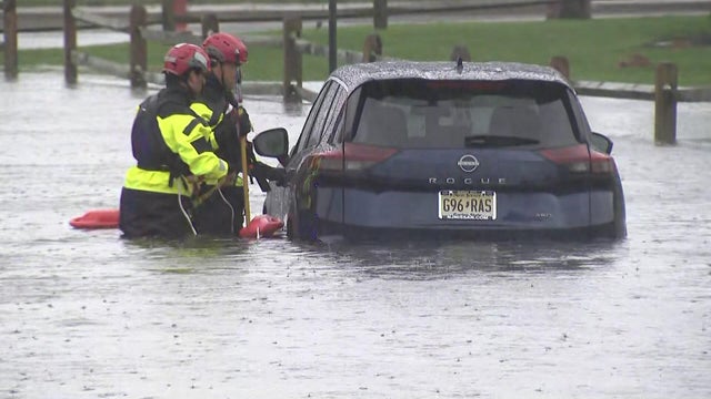 A vehicle with flood waters above the tires 