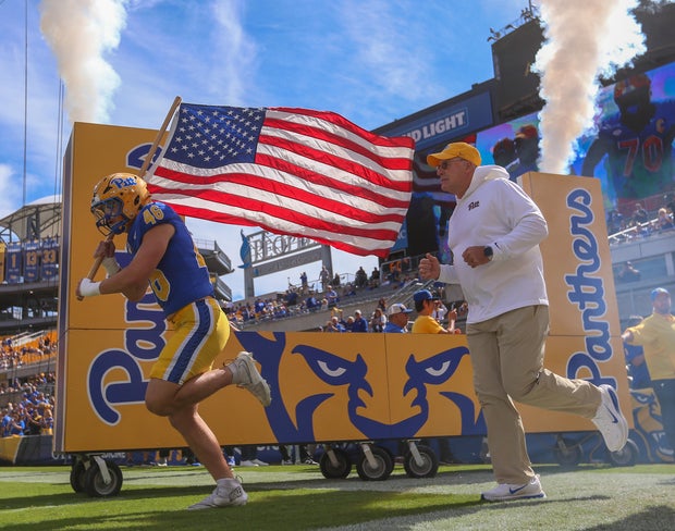 zach-zollers-and-hc-pat-narduzzi-taking-the-field.jpg