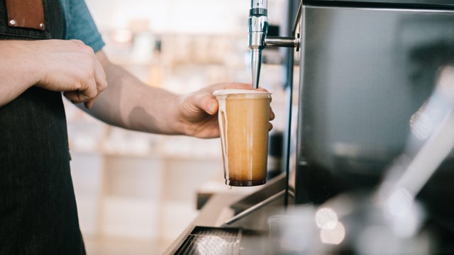 Coffee Shop Barista Pouring Nitro Cold Brew From Tap 