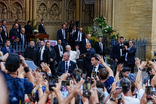 Pope Leo XIV waves to a crowd in France 
