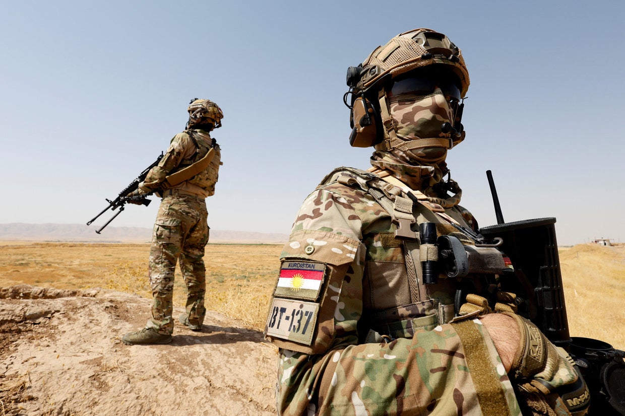 Members of Kurdish special forces patrol on the outskirts of Erbil