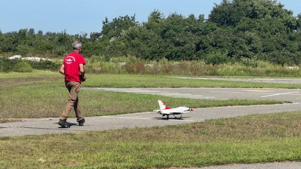 Man operating a miniature plane 