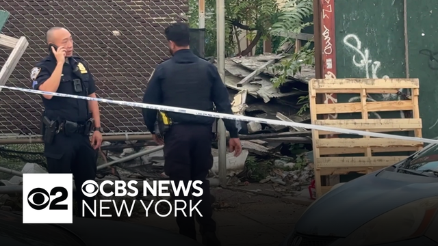 Burned body found in vacant Queens lot, police sources say