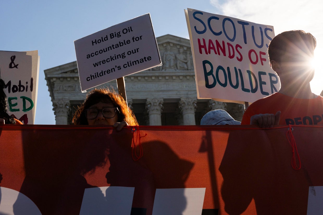 Demonstrators rally against oil corporations involved in a suit against Colorado municipalities outside of the Supreme Court building on Oct. 5, 2026, in Washington, D.C.