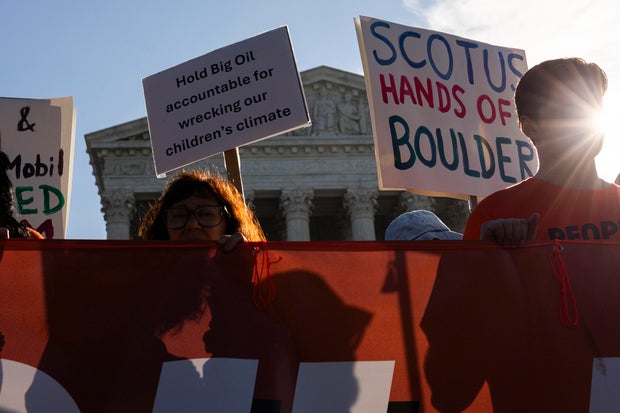 Demonstrators rally against oil corporations involved in a suit against Colorado municipalities outside of the Supreme Court building on Oct. 5, 2026, in Washington, D.C. 