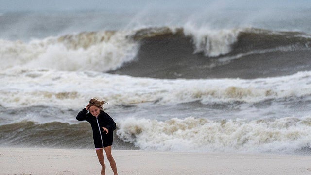 Josephine Bray runs on Orange Beach as the outer bands of 