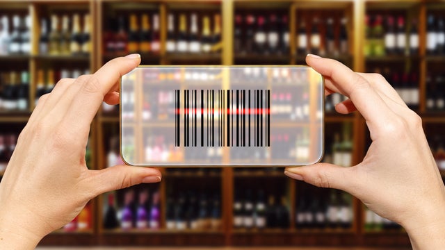 Scanning bar code in retail store using smart phone. Electronic shelf label concept. 