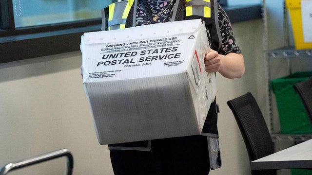 A box of mail-in election material is carried in a Postal Service bin in Raleigh, North Carolina, on Friday, Sept. 11, 2026. 