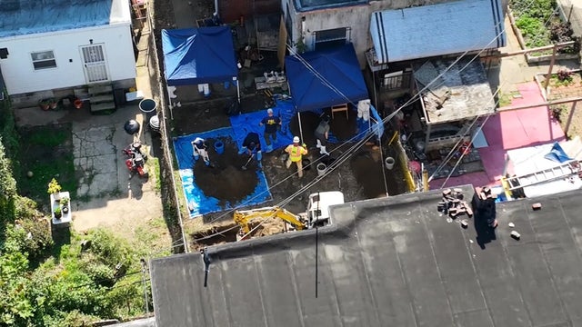 Overhead view as investigators excavate the yard at Eugene Horsch's house in Olney 