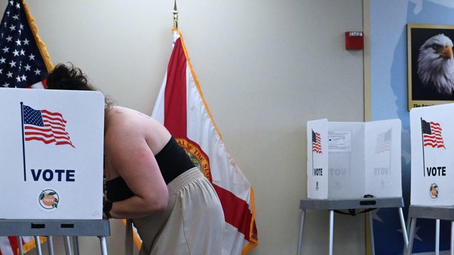 A voter completes a mail-in ballot at the Orange County, 