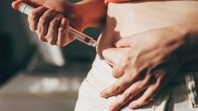 Woman injecting GLP-1 at home 