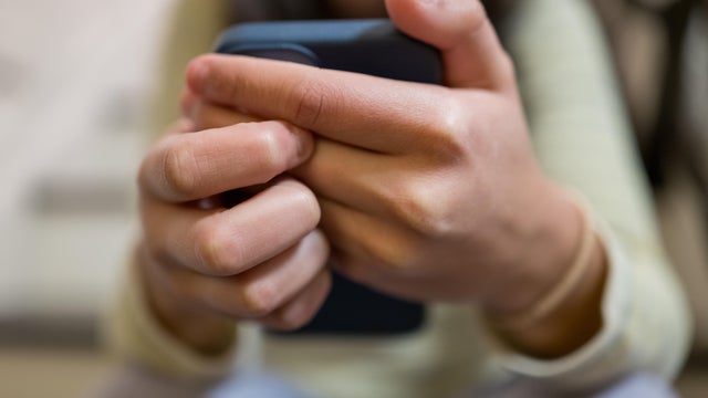 multiracial young woman uses her smart phone 