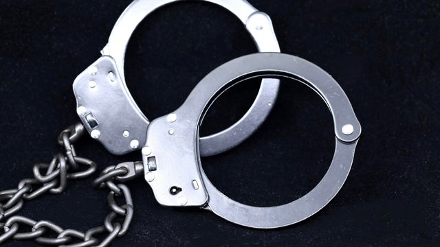 Security concept. Closed handcuffs on black background 