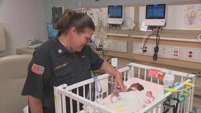 Cheltenham paramedic Jessica Barto looks at baby Isabella at the hospital 
