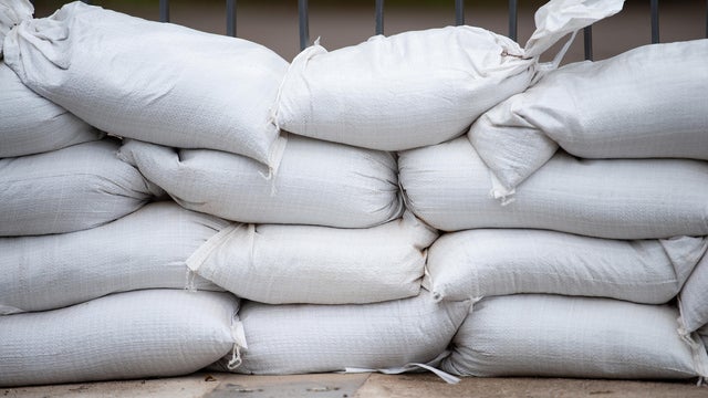 Sandbags for flood defense, river Moselle Trier in Rhineland Palatinate, flooded trees and paths, high water level, climate change 