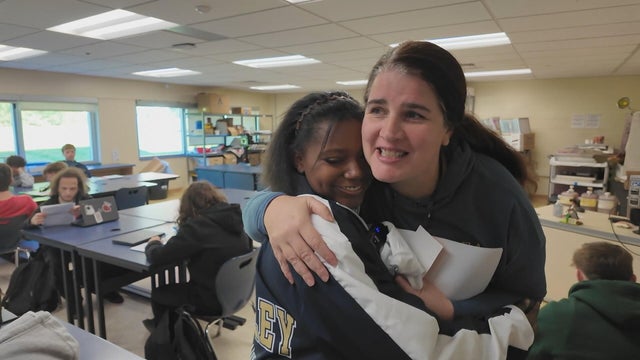 A student and teacher hug at Sun Valley High School 